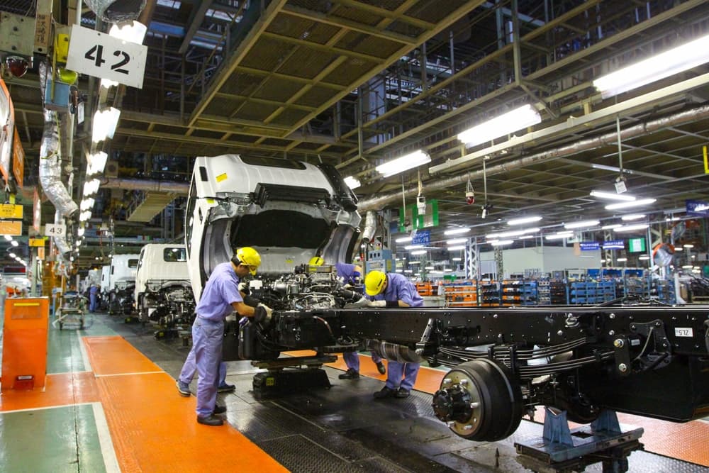 Worker on a heavy vehicle production line in the automotive industry