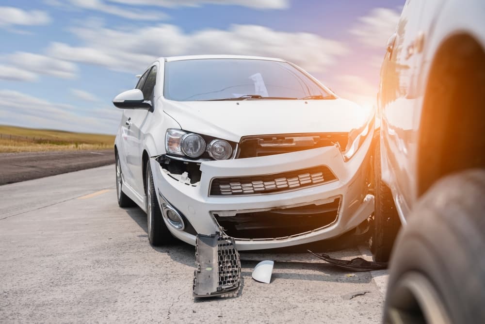 Front of white car get damaged by accident on the road, Car crash accident on street.
