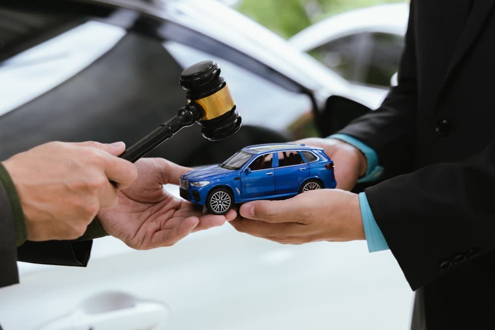 A judge presides over a legal case concerning a car accident claim. The nervous driver awaits the verdict as lawyers present their evidence.