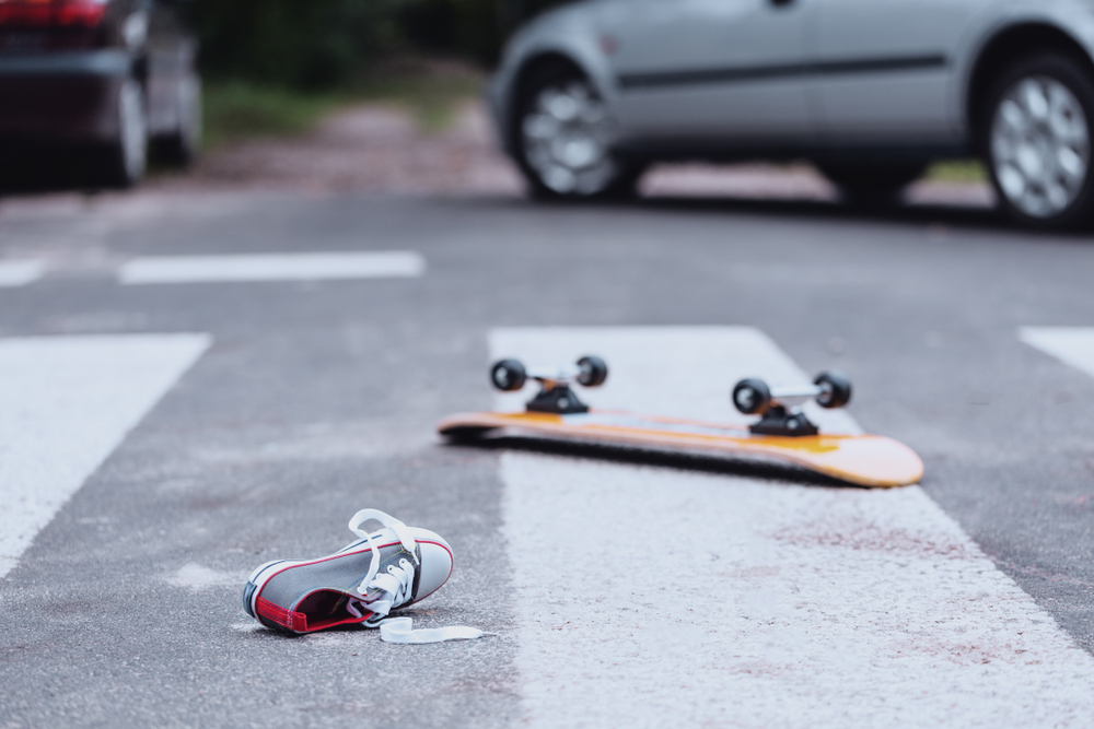 Skateboard and shoe left on crosswalk after a serious pedestrian accident