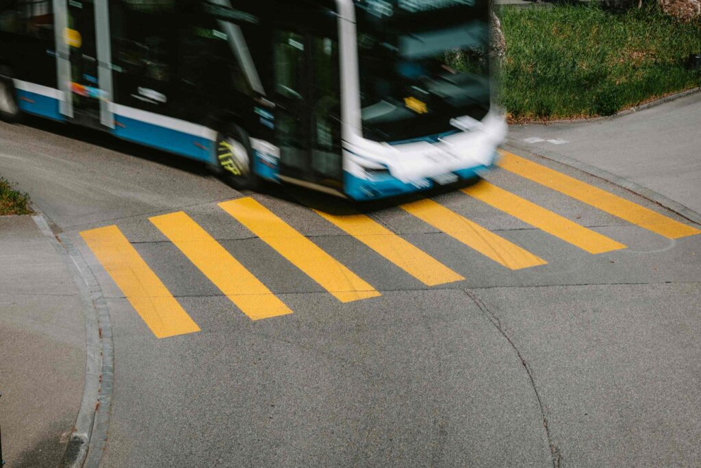 Fast-moving city bus driving over crosswalk, served by Port Richey Bus Accident Lawyers.