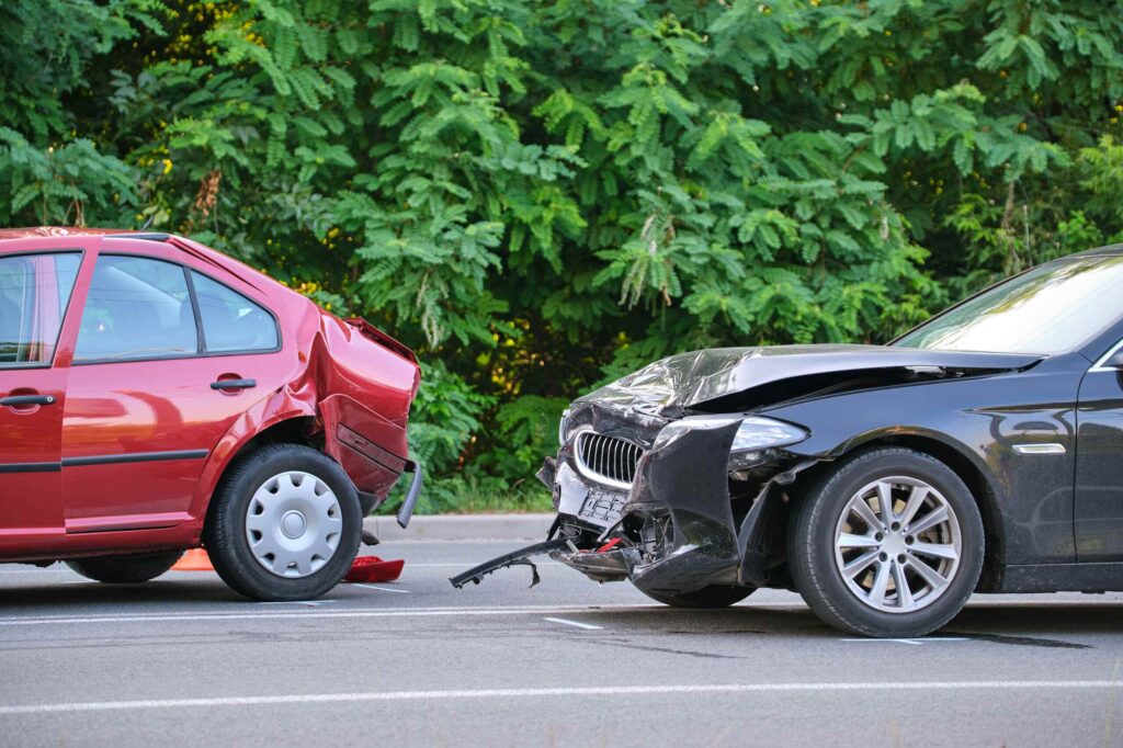 Rear-end collision between red and black cars, handled by Zephyrhills Car Accident Lawyers.