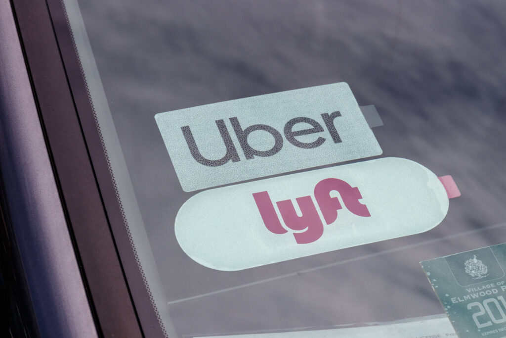 Uber and Lyft logos on windshield, served by Zephyrhills Rideshare Accident Lawyers.